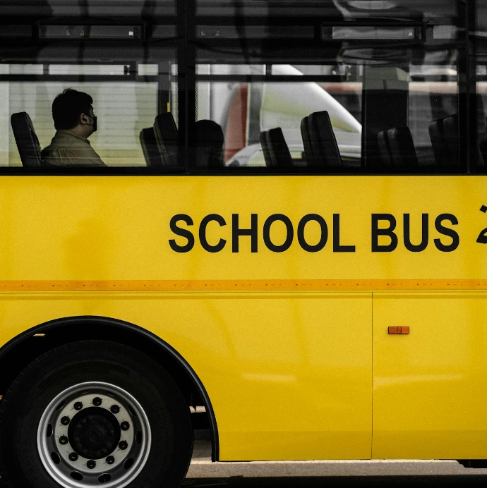a yellow school bus with arabic writing on the side